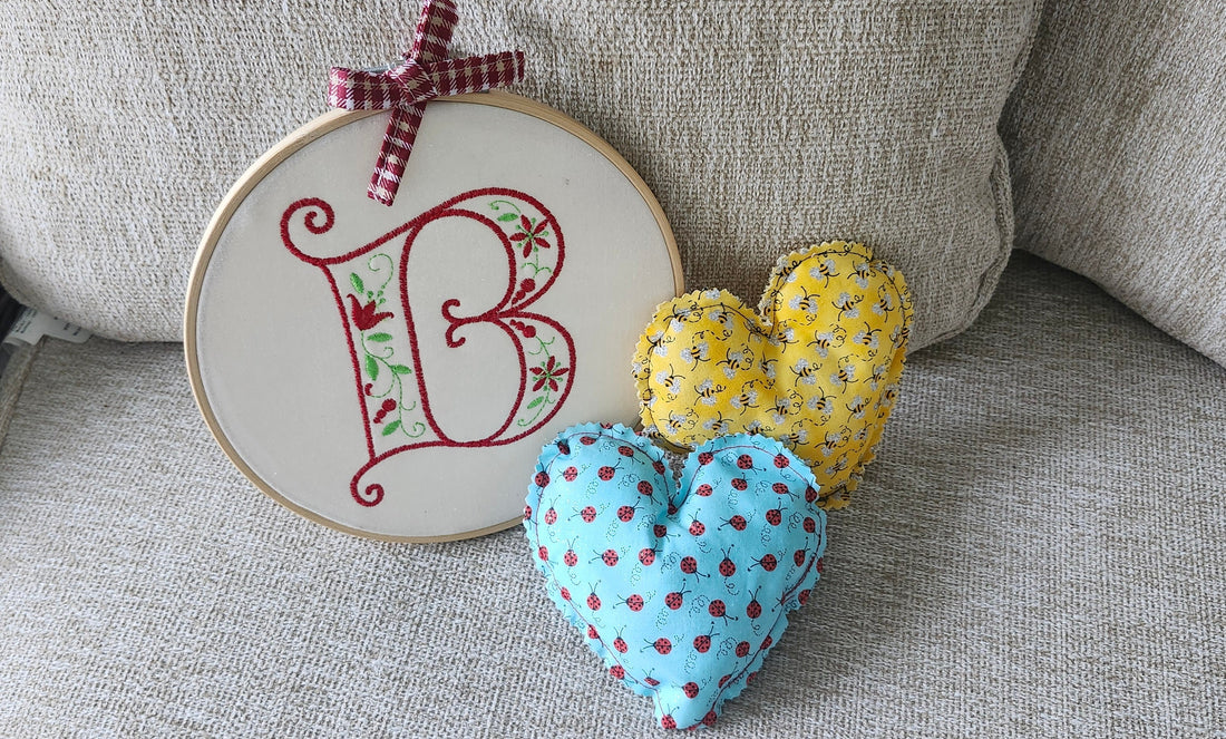 Handmade embroidery hoop wall art and heart cushion on a cozy shelf for home decor by Luniquedesigns