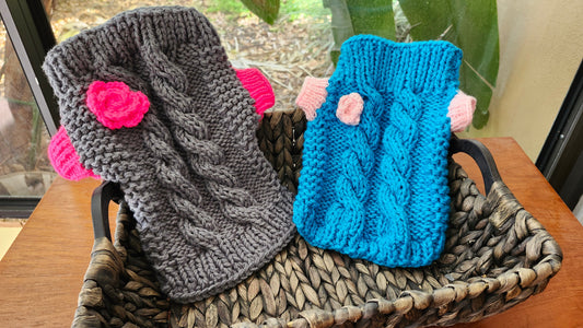 A beautiful, custom-made dog sweater neatly laid out on a clean surface under bright, natural daylight, highlighting the high-quality stitching