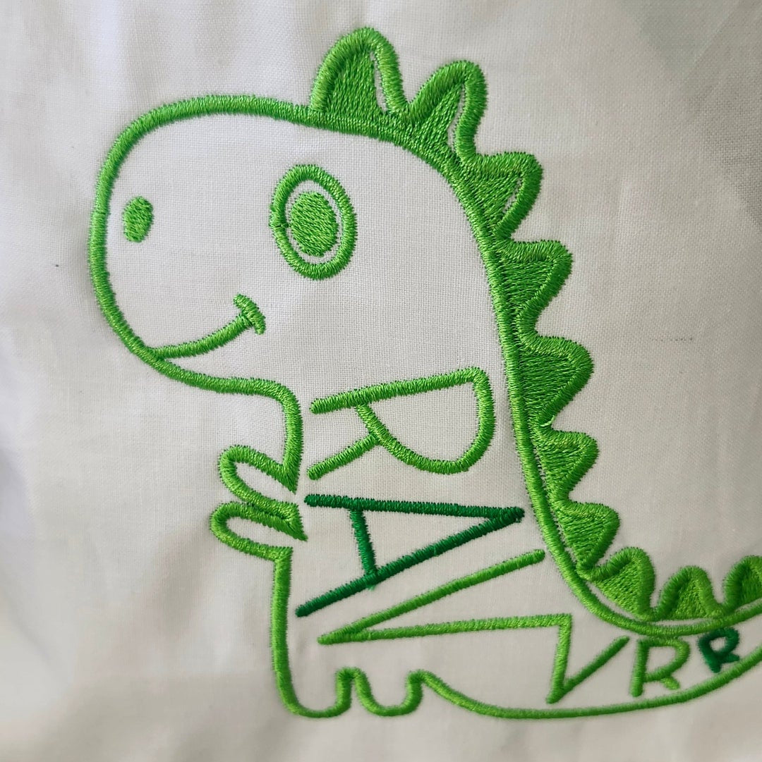 Green dinosaur with 'RAK' text on a white background