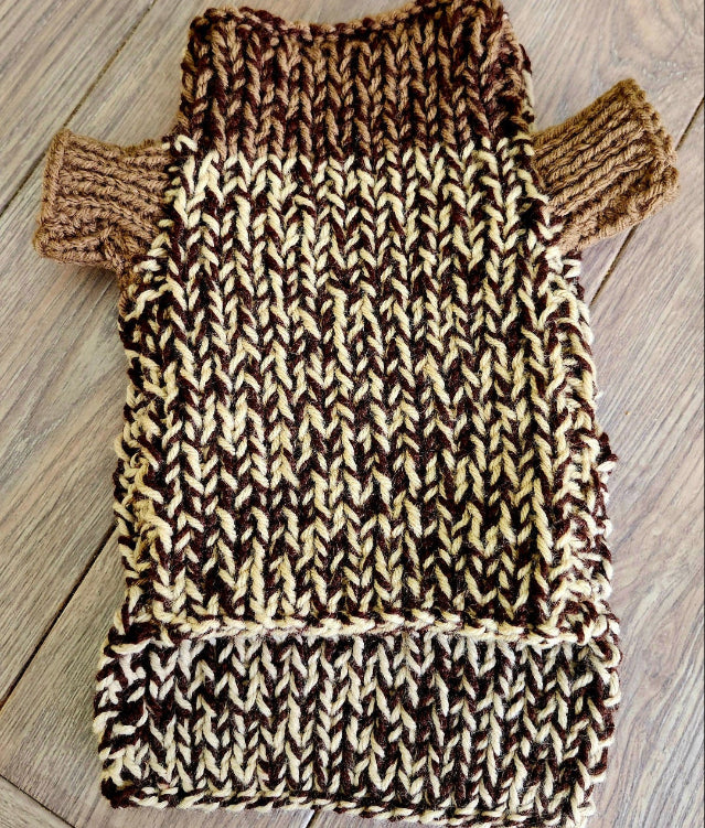 Knitted dog sweater on a wooden table