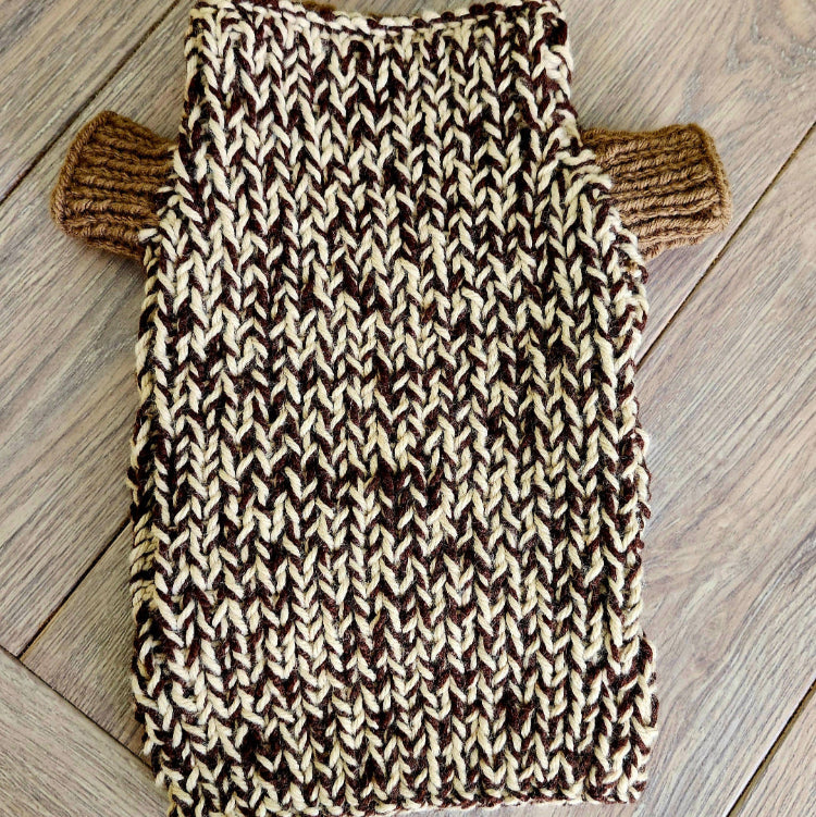 Knitted dog sweater on a wooden table